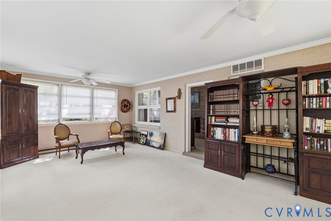 Recessed lighting, ceiling fan, and multiple windows with roller shades