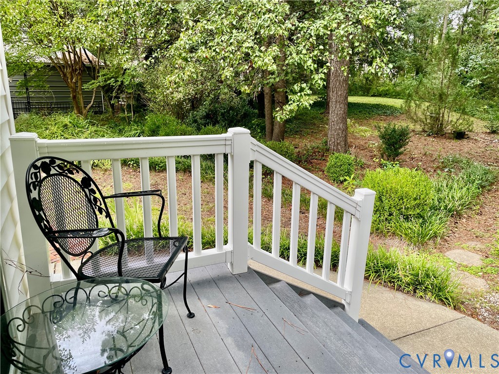 Deck with composite decking, white railing, and exterior siding