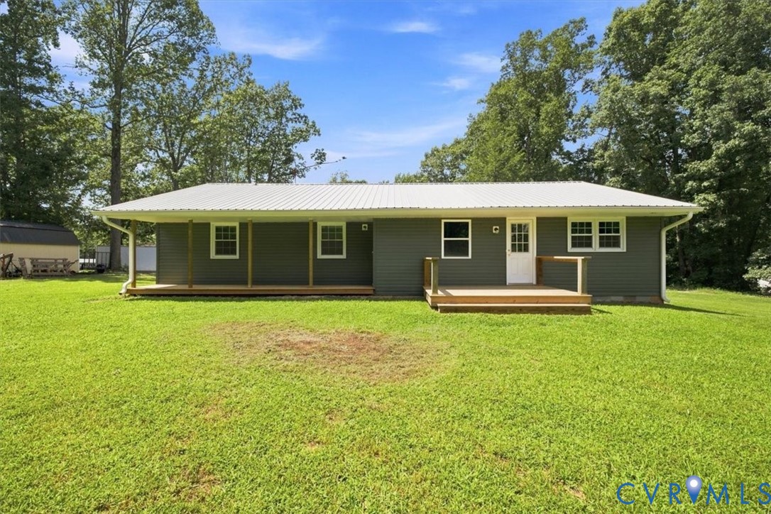 Level backyard with covered porch and deck.