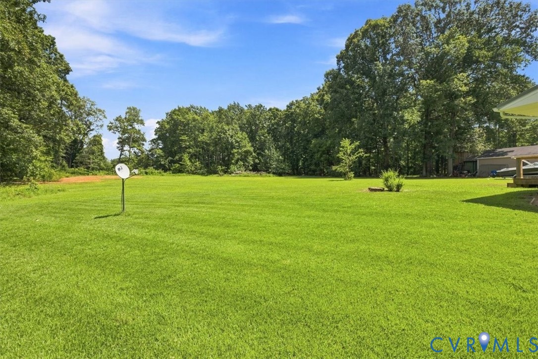 Expansive green lawn with mature perimeter trees
