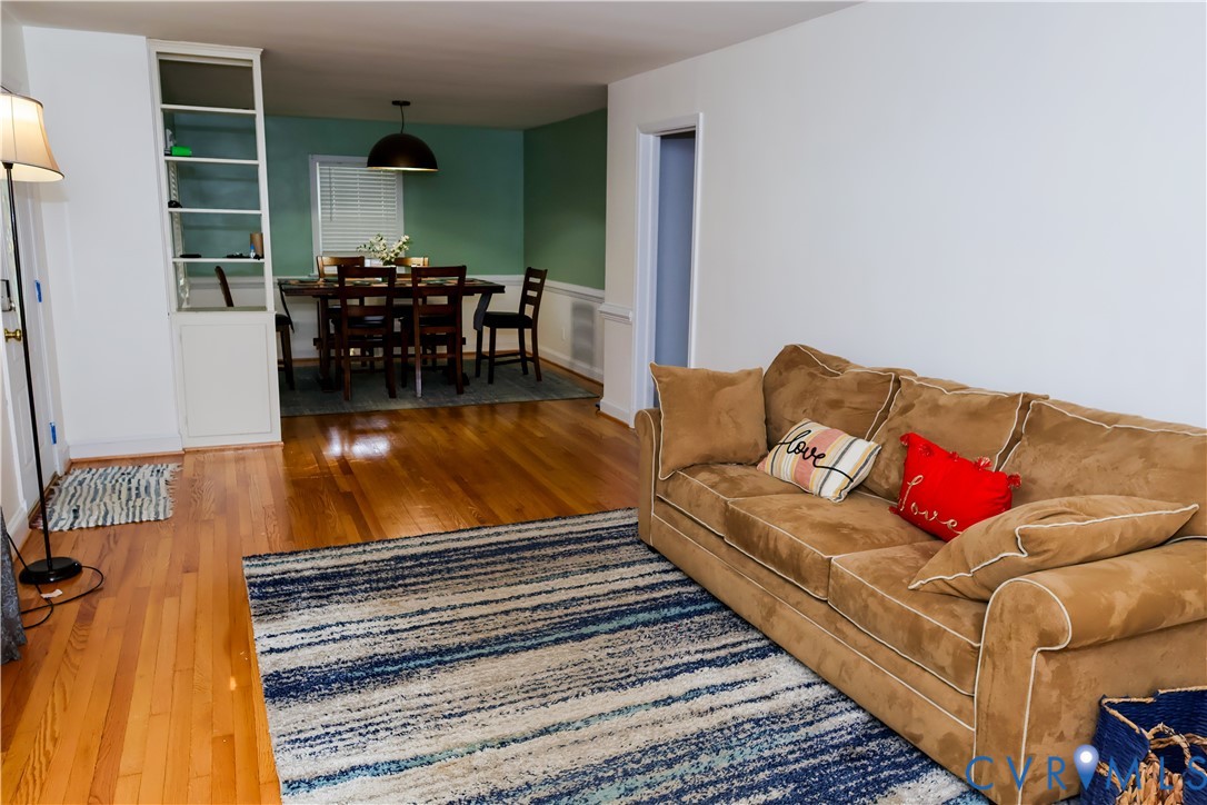 Hardwood flooring throughout, built-in shelving, and a distinct dining area with wainscoting Hardwood flooring throughout, built-in shelving, and a distinct dining area with wainscoting