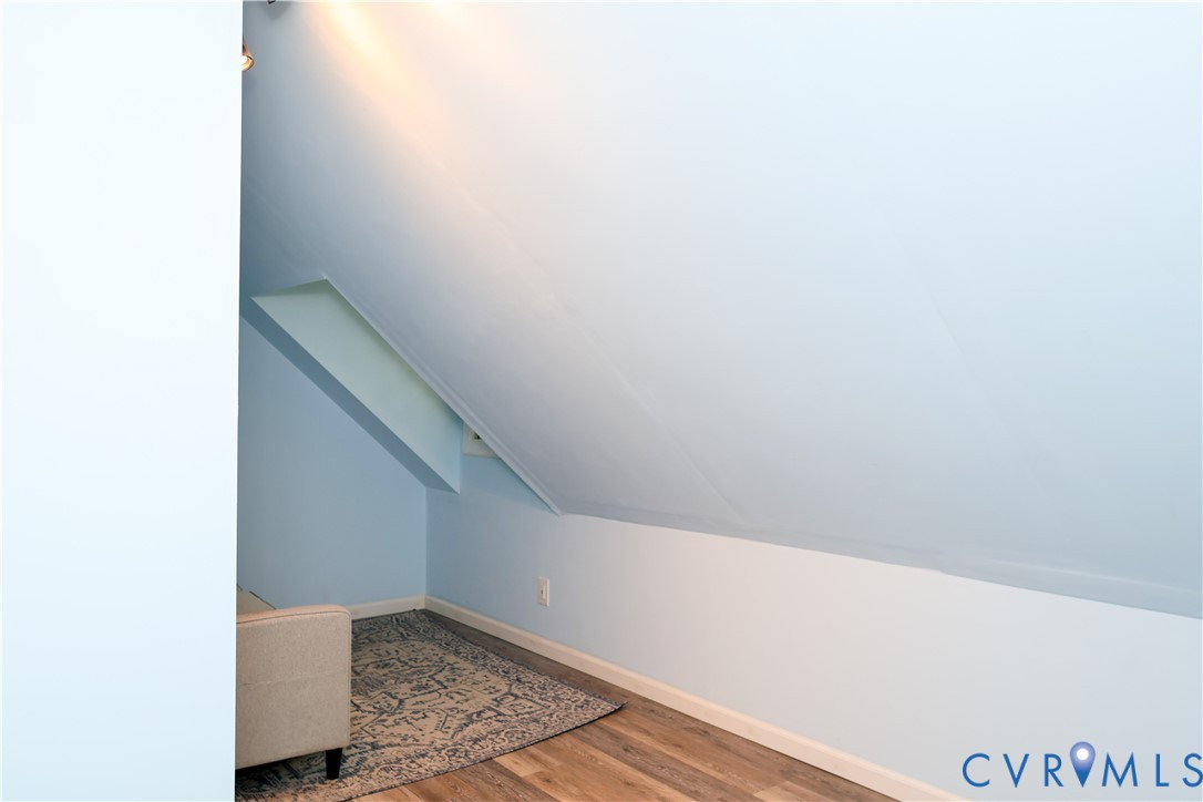 Bonus room off the primary w/Wood-finish flooring, Window facing the front yard.