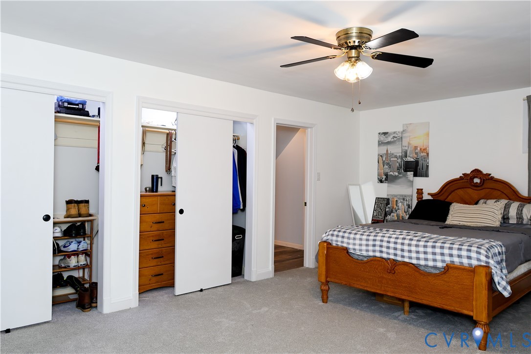 Ceiling fan with light fixture, two sliding closet doors, carpet with bonus room.