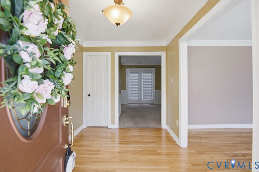 Wood-finish flooring, crown molding, and recessed lighting