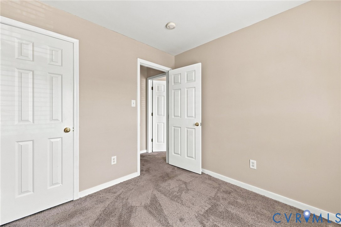 Neutral-toned walls complement the gray patterned carpeting