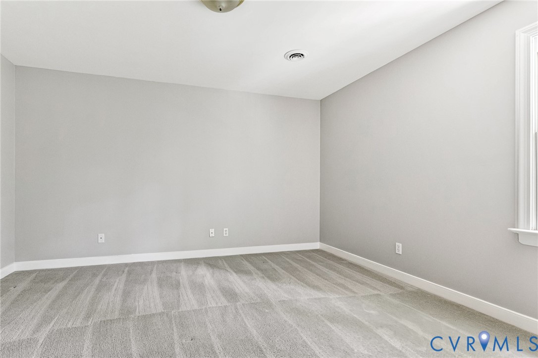 Wall-to-wall carpeting, light gray wall finishes, white trim, and a ceiling-mounted light fixture