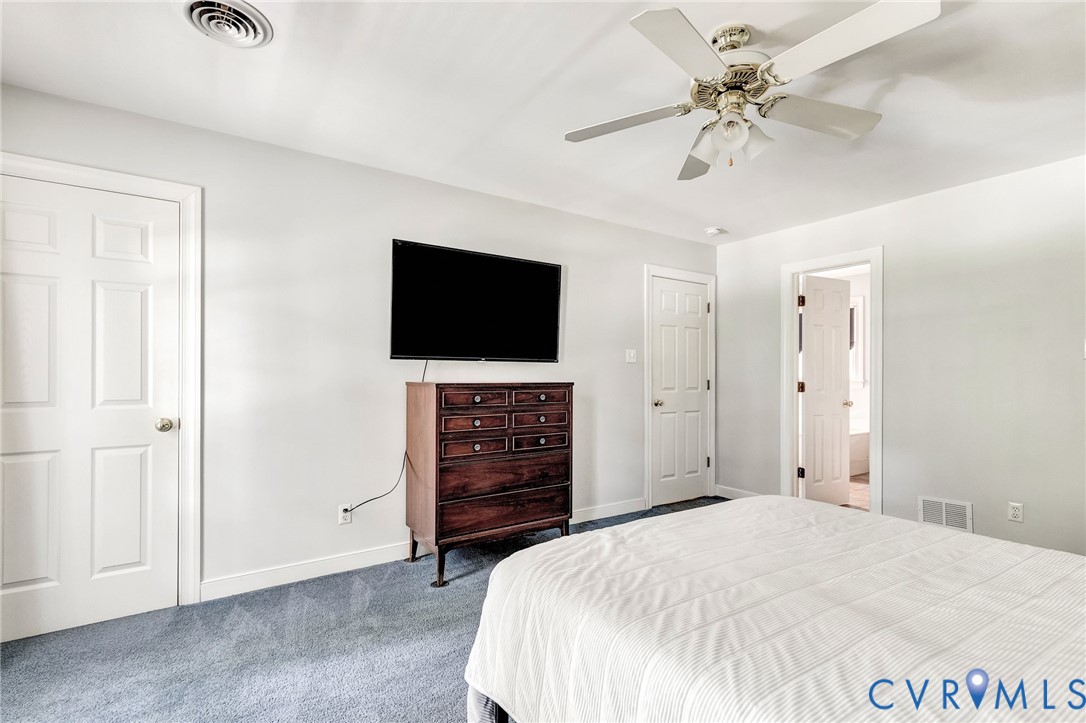 Recessed ceiling fan with integrated lighting, soft blue carpeting, and white paneled doors
