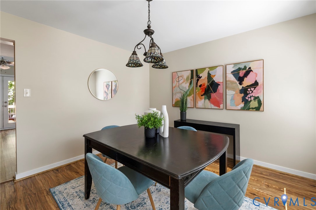 Wood-finish flooring, recessed lighting, and a decorative chandelier