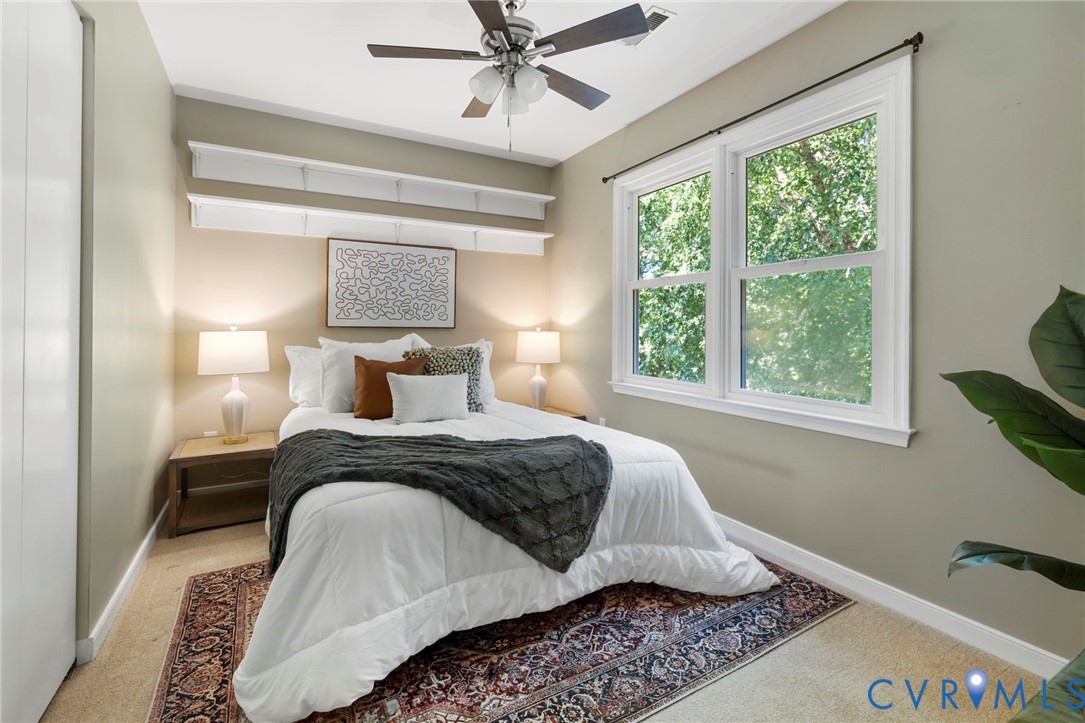 Dual windows, ceiling fan, and built-in shelving