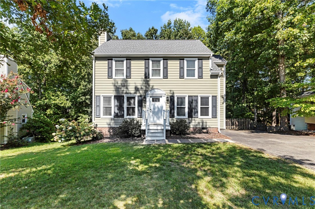 Two-story residence featuring siding exterior, white trim, and dark shutters Two-story residence featuring siding exterior, white trim, and dark shutters