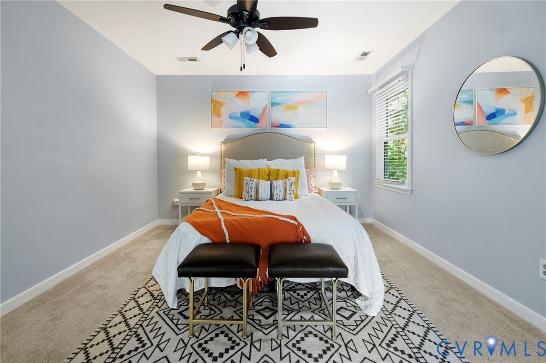 Carpeted flooring, window with blinds, ceiling fan with integrated lighting, and light blue wall tones