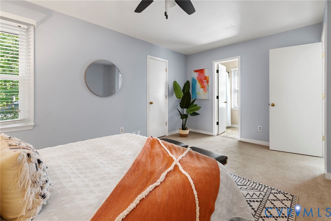 Carpeted flooring, ceiling fan, and window with blinds