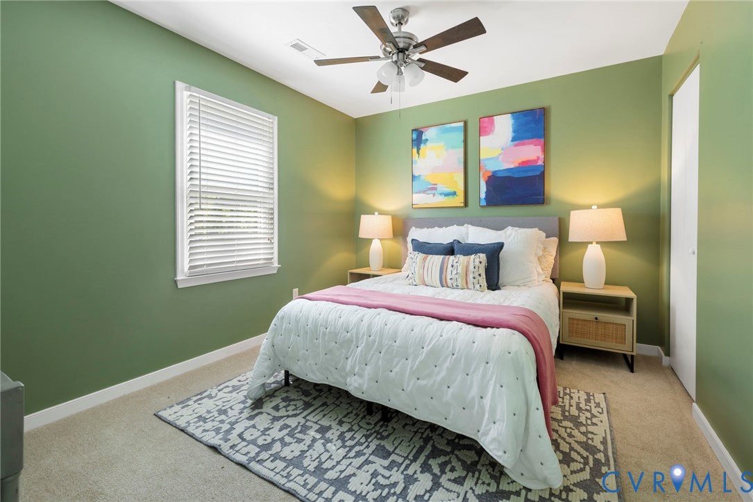 Carpeted flooring, window with blinds, ceiling fan with light fixture, and closet with white door
