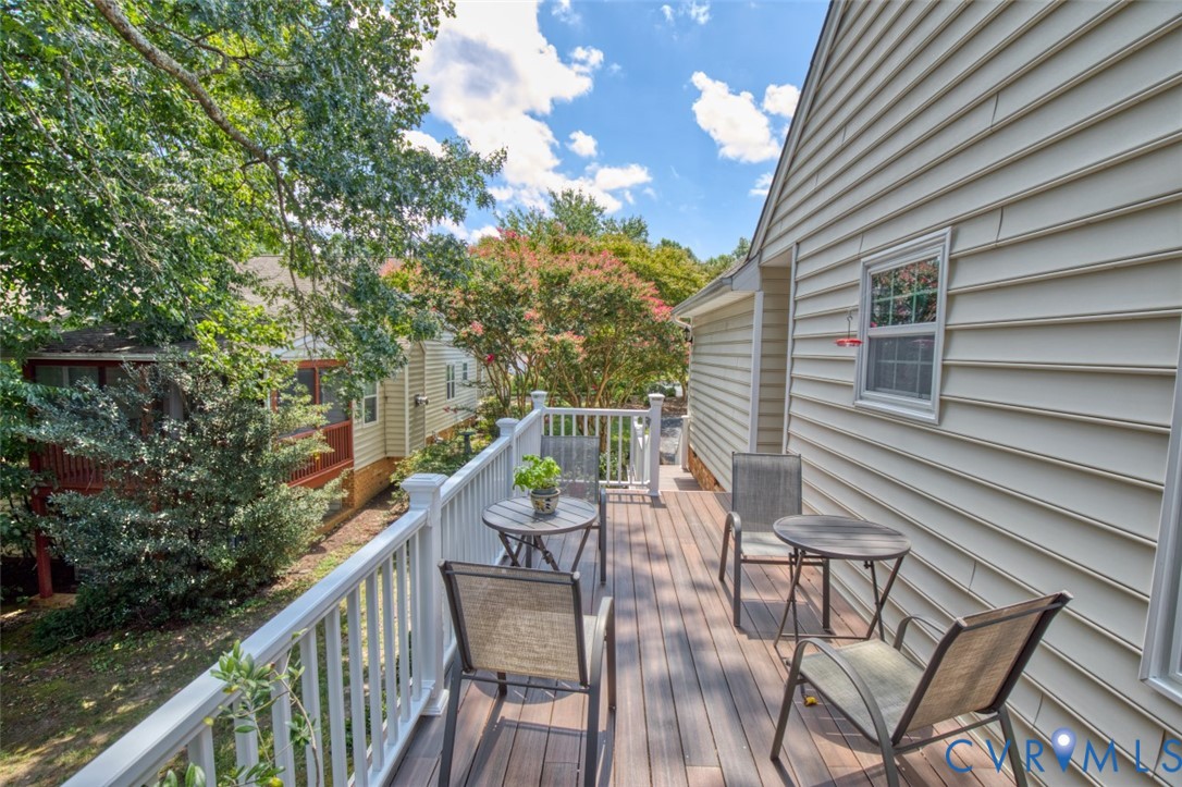 Expansive outdoor deck with composite decking, white railing, and exterior siding