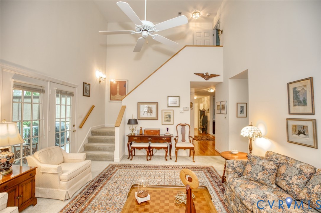 Soaring two-story foyer with ceiling fan and recessed lighting anchors this open-concept living space