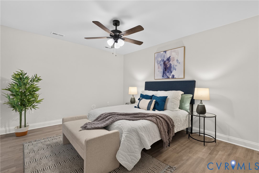 Neutral wall finish, wood-finish flooring, ceiling fan with integrated lighting, recessed lighting, and white trim
