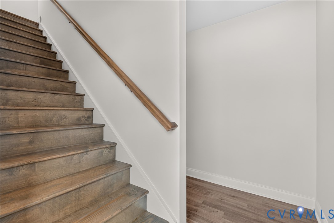 Wood-finish staircase with a light-toned handrail