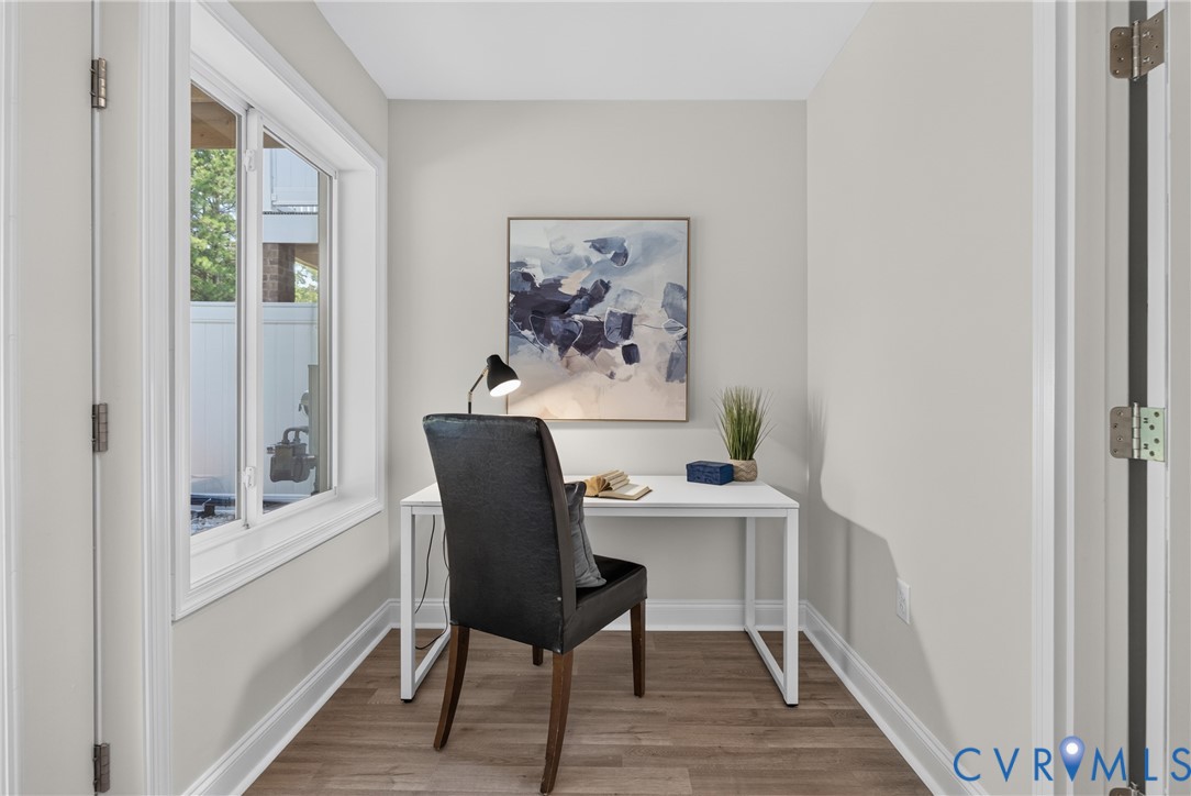 Recessed alcove featuring wood-finish flooring and a white-framed window