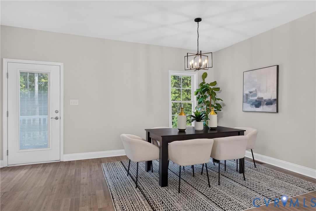 Recessed lighting and wood-finish flooring complement neutral wall tones
