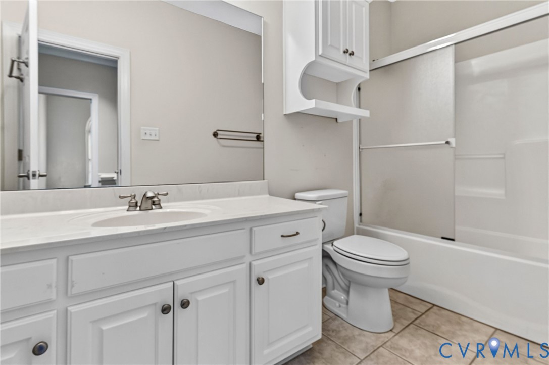 White vanity with integrated sink, brushed nickel faucet, and white upper cabinetry