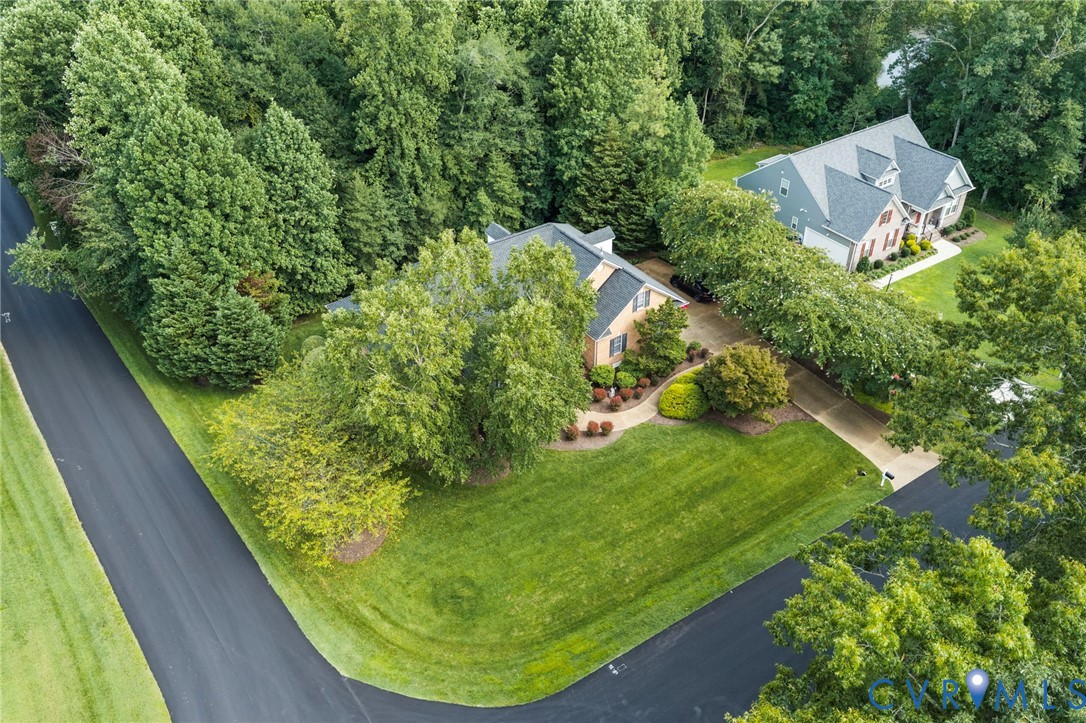Residence featuring a brick exterior, multiple gables, and a mature treed setting Residence featuring a brick exterior, multiple gables, and a mature treed setting