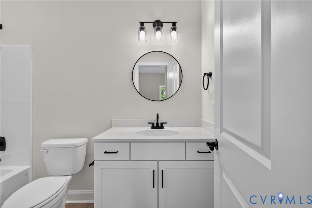 White vanity with quartz countertop, undermount sink, and matte black hardware