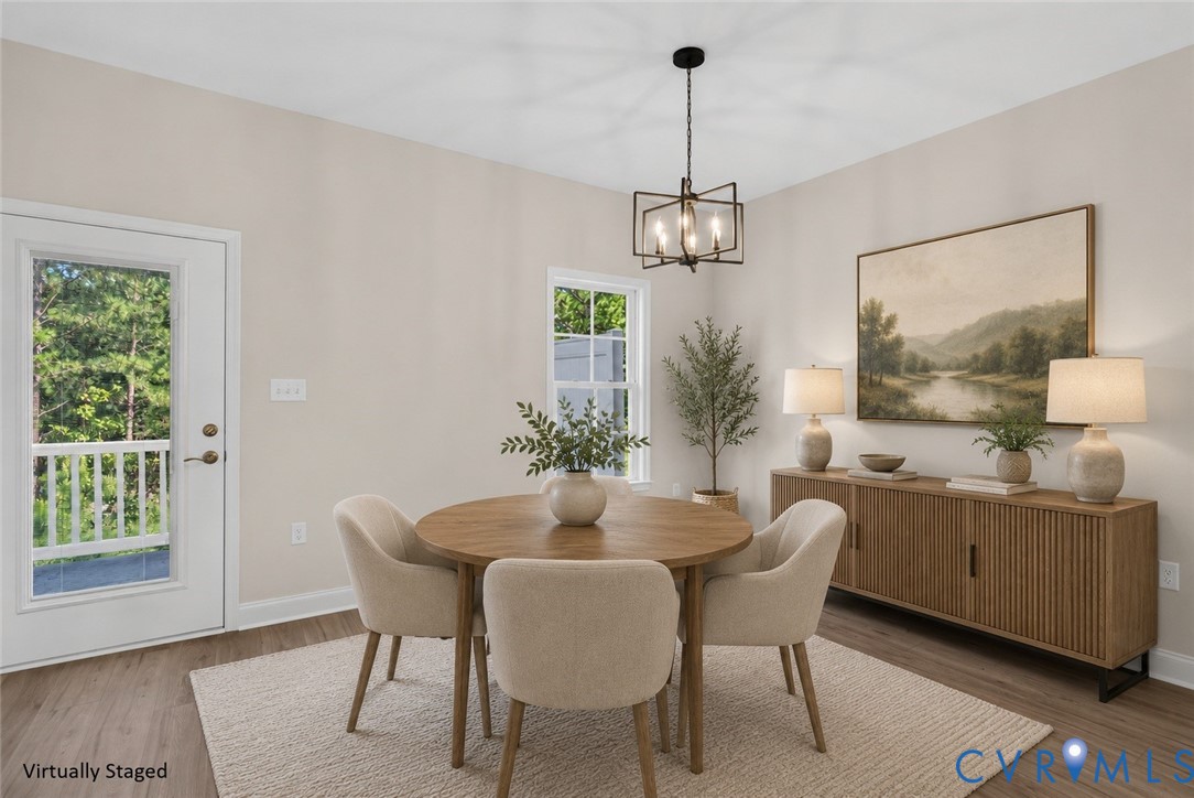 Wood-finish flooring, a contemporary chandelier, and a built-in sideboard with fluted detailing