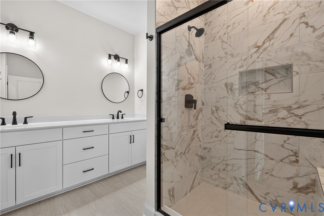 Dual vanity with white cabinetry and matte black hardware