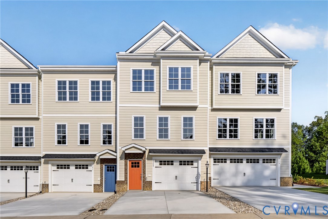 Contemporary townhome with siding exterior, multi-pane windows, and a two-car garage Contemporary townhome with siding exterior, multi-pane windows, and a two-car garage