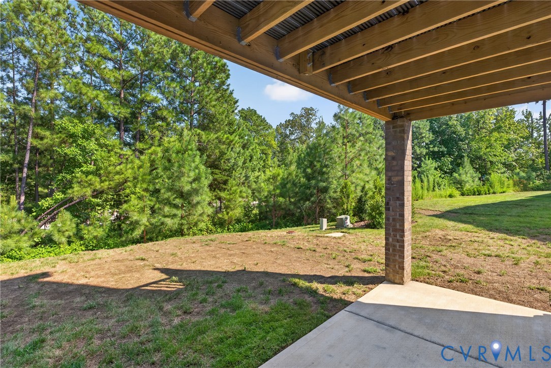 Covered outdoor patio with a concrete slab and a brick support column