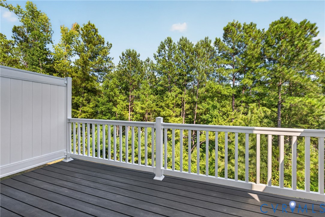 Outdoor deck with dark composite decking and white railings