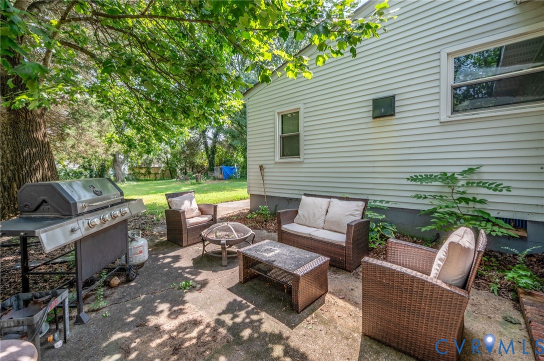 Private outdoor patio with concrete paving and surrounding mature foliage Private outdoor patio with concrete paving and surrounding mature foliage