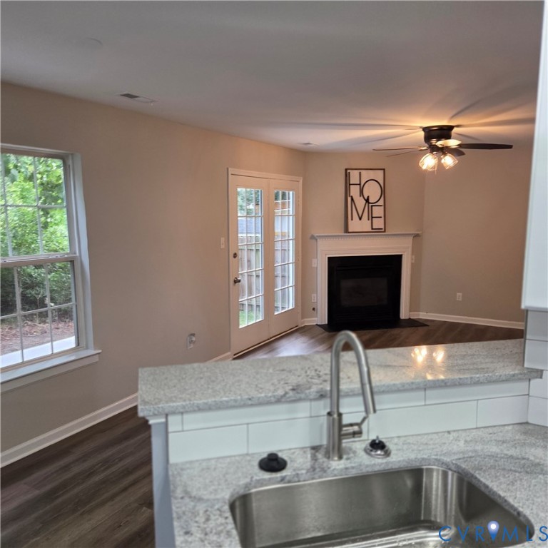 Kitchen bar with speckled countertop and stainless steel sink