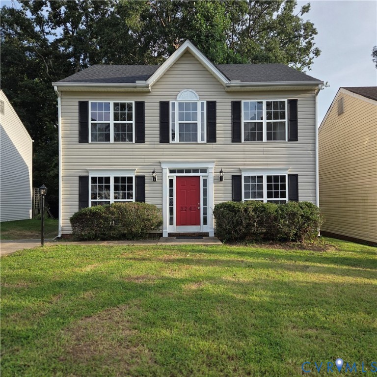 Two-story residence featuring light-colored siding, a prominent red front door with white trim, and black louvered shutters