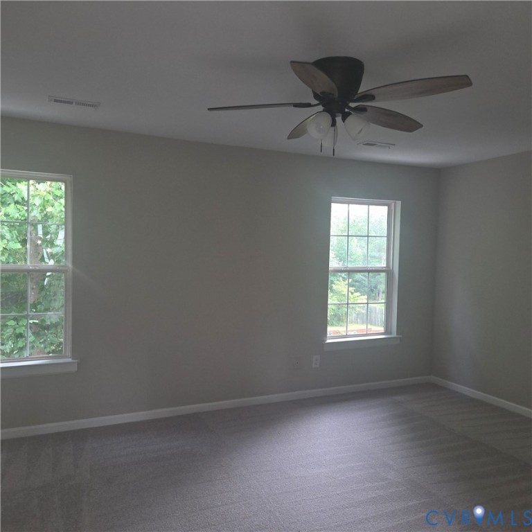 Neutral-toned walls complement the gray carpeting