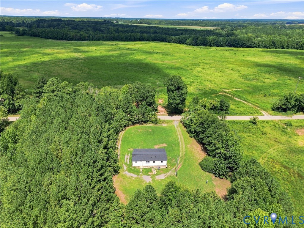 Expansive green acreage with a distant tree line