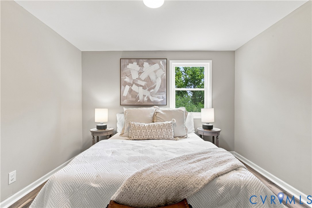 Neutral wall color, wood-finish flooring, white trim, and a window for natural light