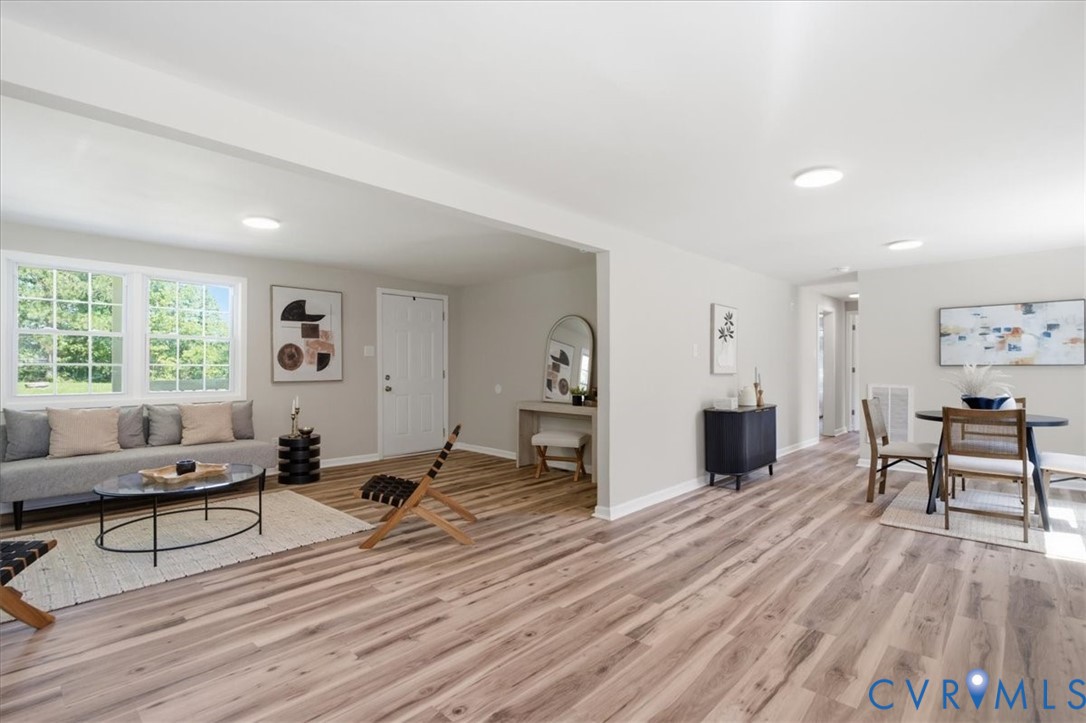 Expansive wood-finish flooring throughout the open-concept living space