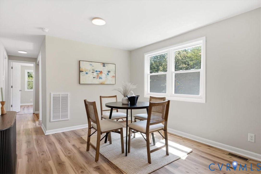 Light wood-finish flooring complements neutral wall tones