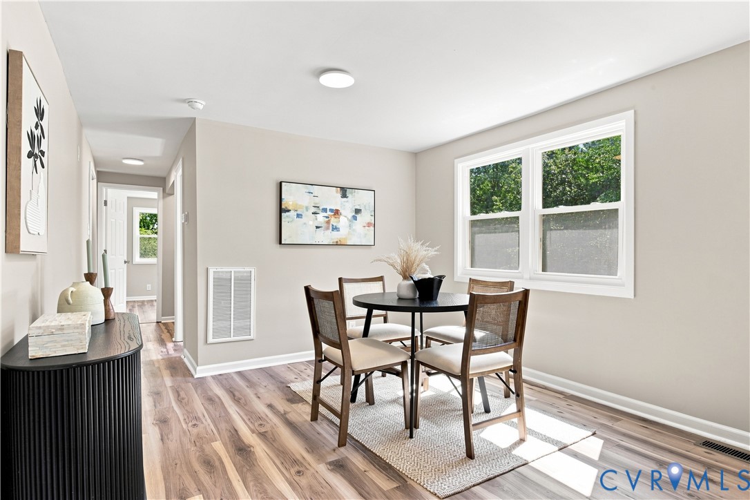 Recessed lighting, wood-finish flooring, and light-toned wall paint create a bright interior