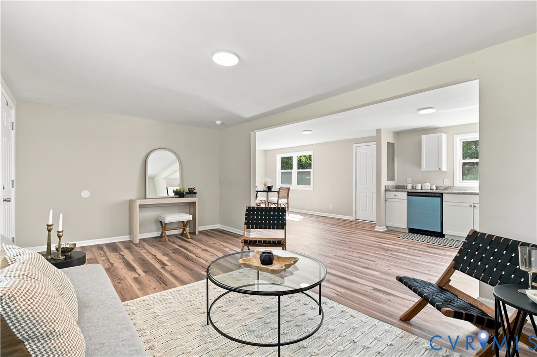 Open-concept living area with wood-finish flooring, recessed lighting, and light-toned wall paint
