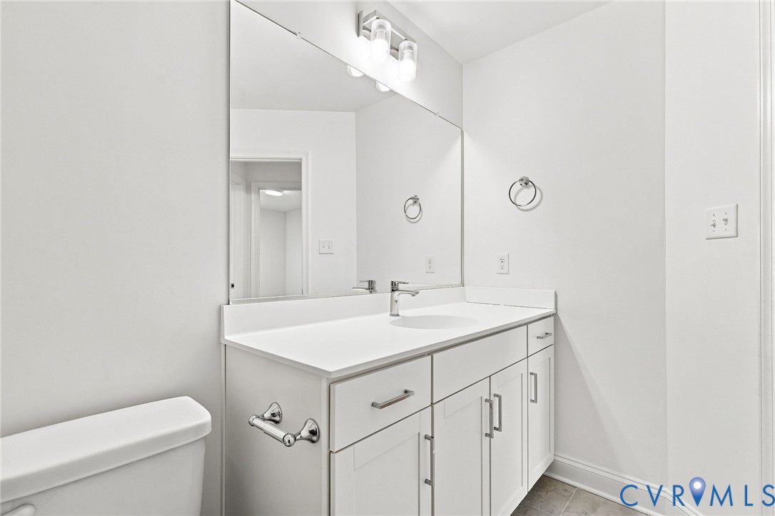 White vanity with undermount sink, contemporary faucet, and integrated countertop
