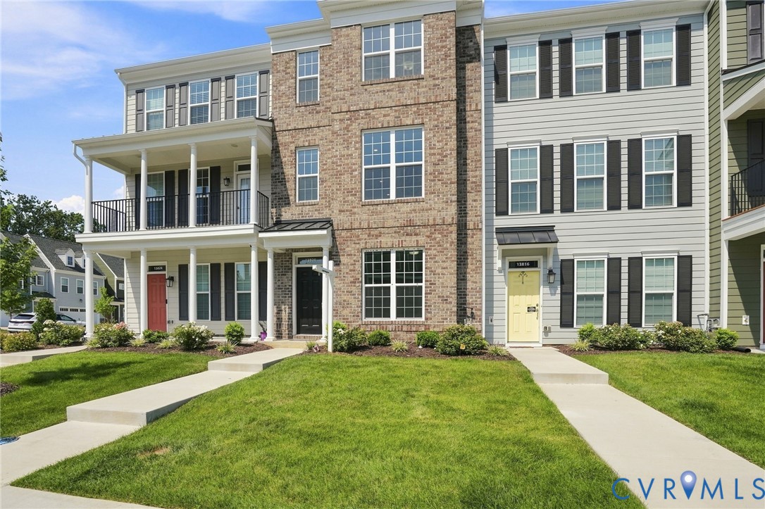 Brick and siding exterior with black shutters, multiple windows, and covered front entry Brick and siding exterior with black shutters, multiple windows, and covered front entry
