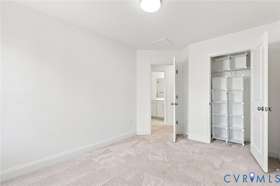 Light-toned wall-to-wall carpeting throughout
