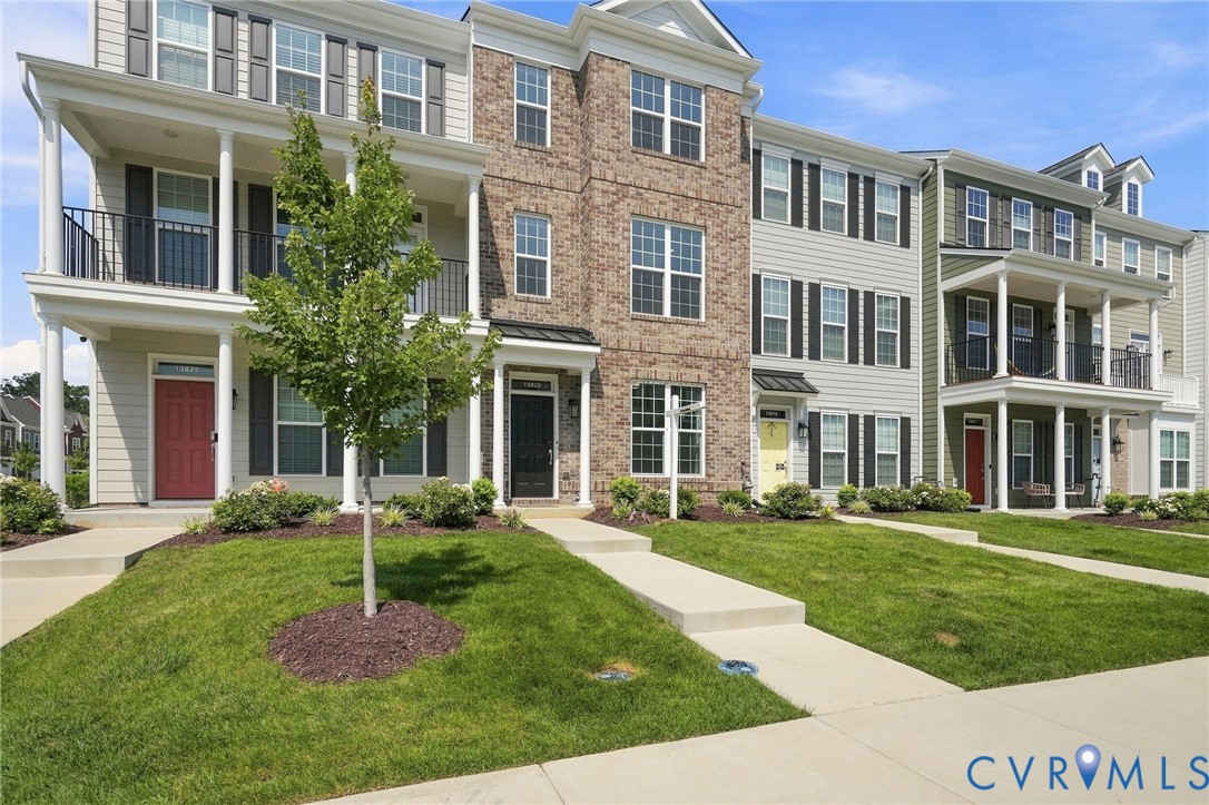 Multiple townhomes featuring varied exterior finishes including brick and siding Multiple townhomes featuring varied exterior finishes including brick and siding
