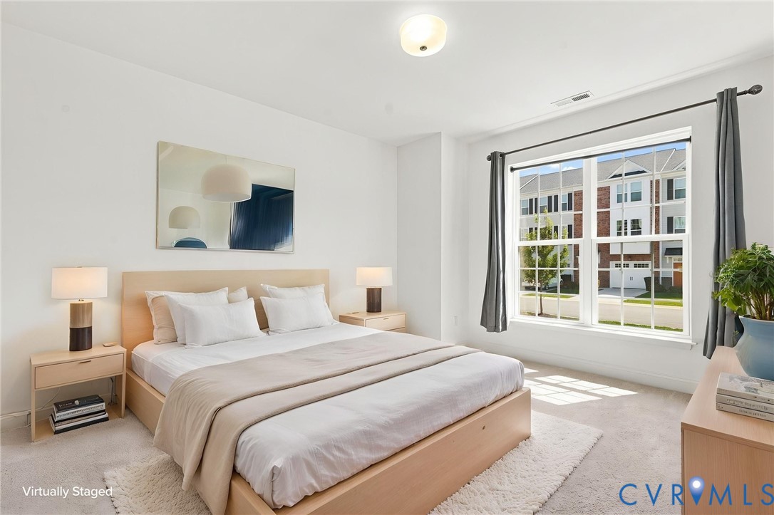 White walls, recessed lighting, and a large window with white trim