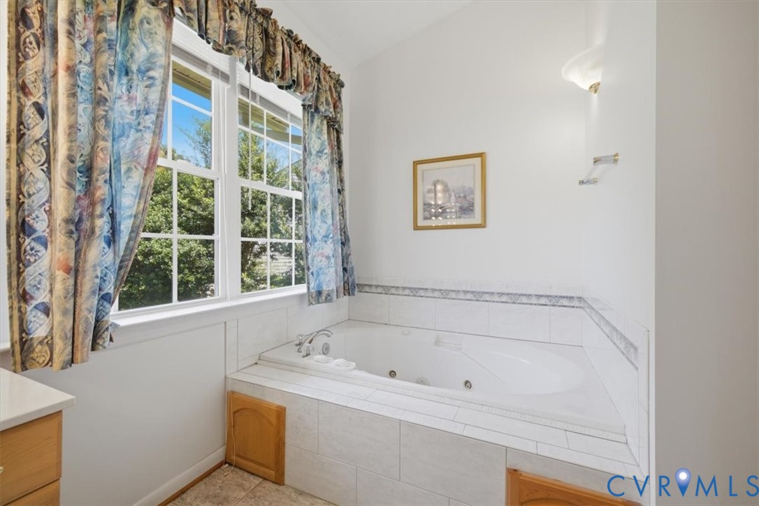 Built-in jetted tub with tile surround and decorative tile trim