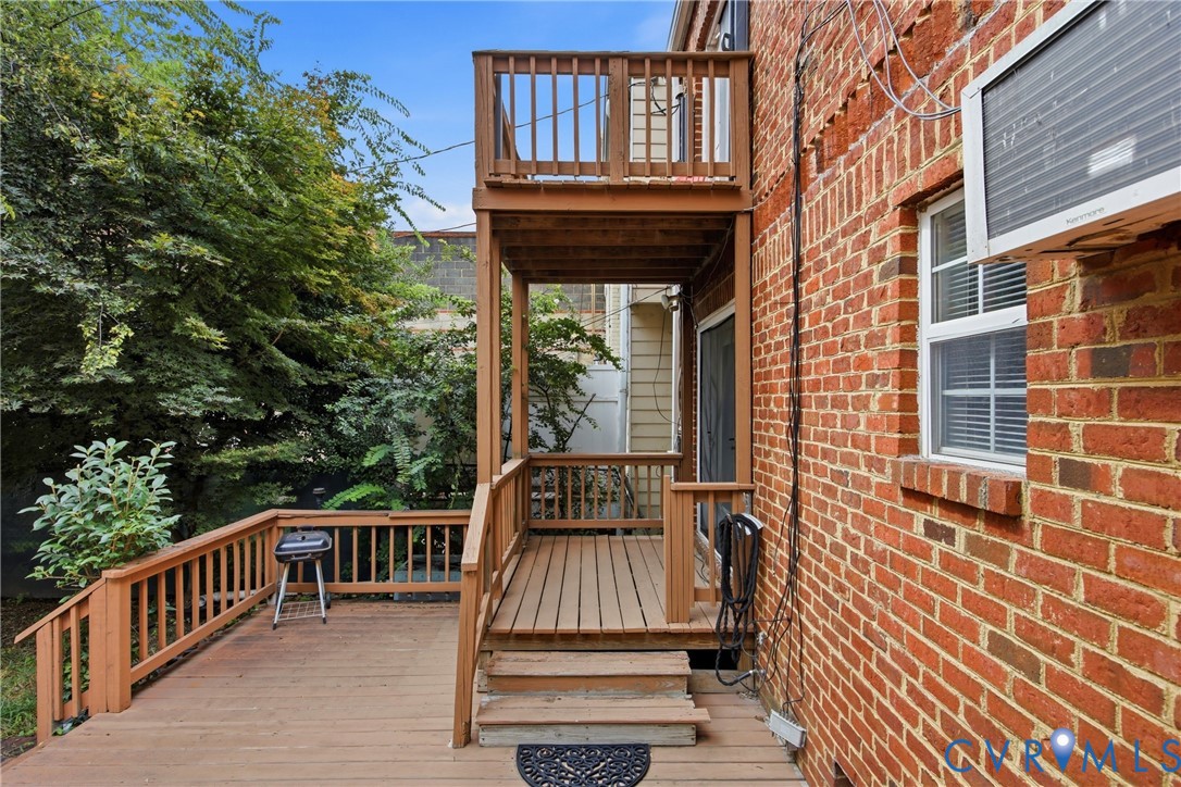 Multi-level wood deck with wood railings, outdoor living space