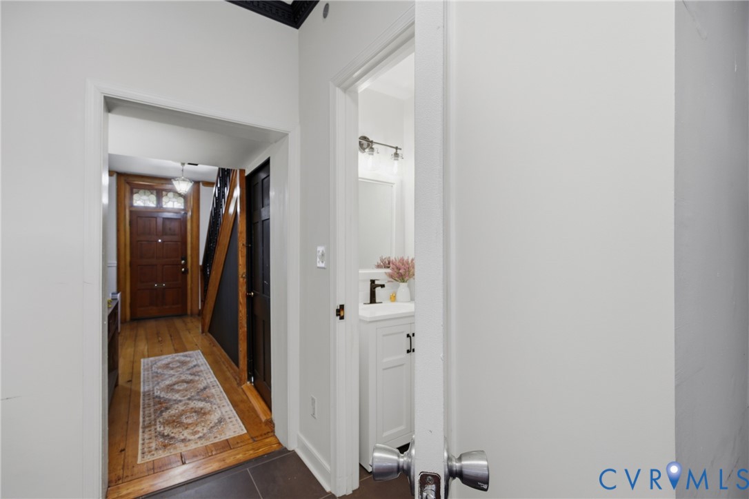 Wood flooring, entry to half bath