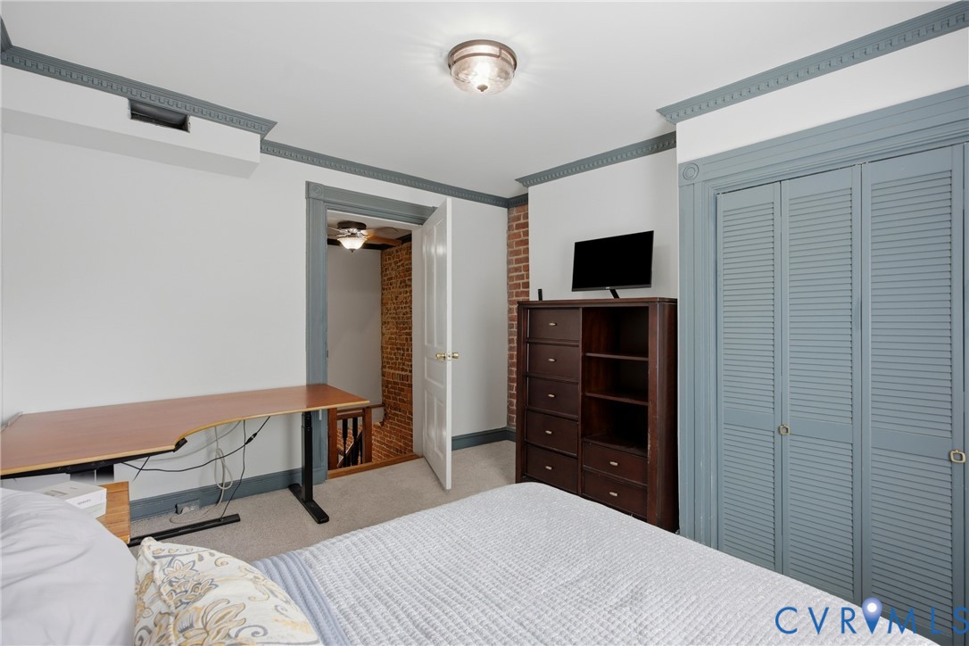 2nd bedroom, carpeted flooring, crown molding, double louvered closet doors